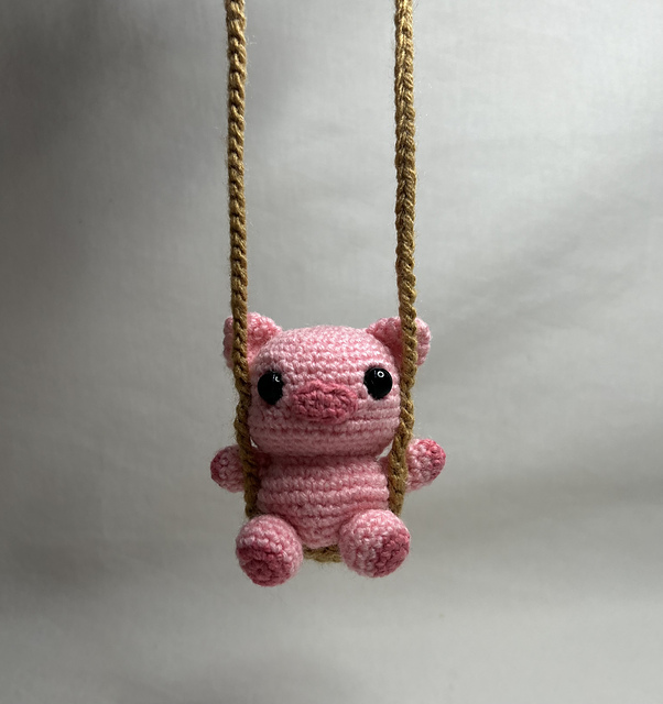 Percy, the little pig on a swing
