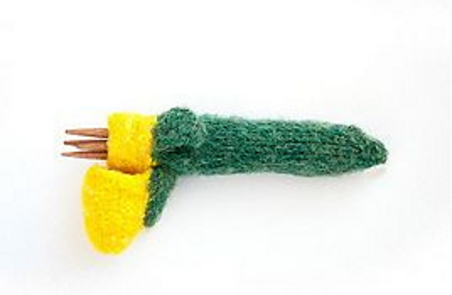 Needles in  Corncob- A needle holder. 