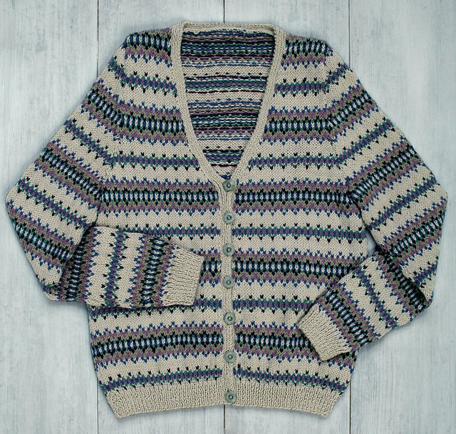 Patterned cardigan showing repeated knitted motifs across the body and sleeves