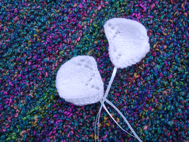 Tiny Knitted Bonnet With Lace Edge