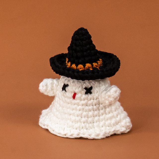 A little ghost wearing a witch hat