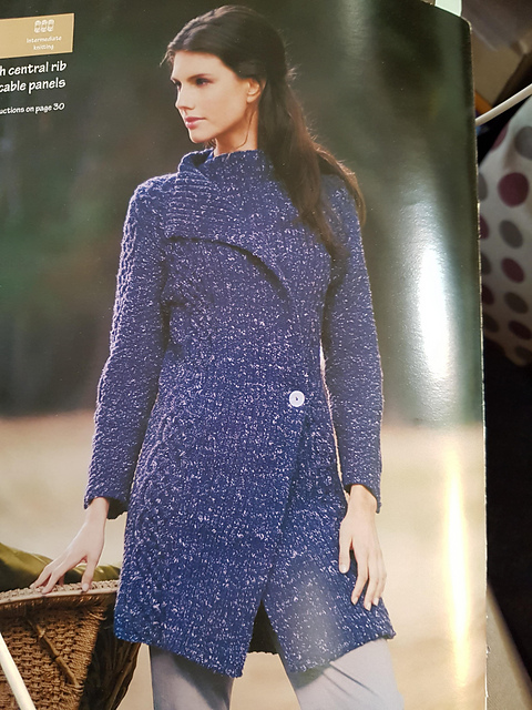 Coat with central rib and cable panels