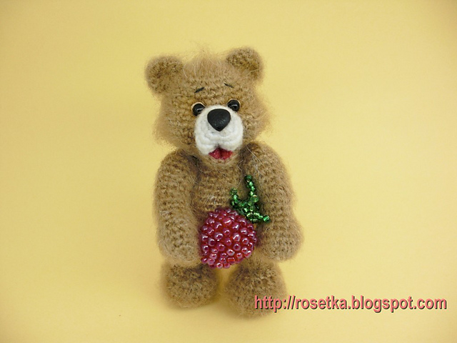 Teddy-bear with raspberry.
