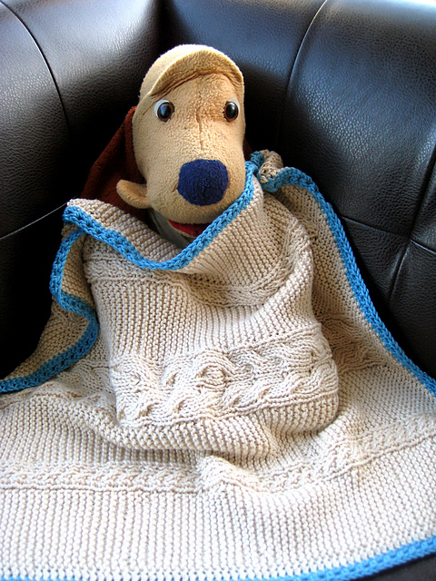 A Reversible Cabled Baby Blanket with Optional Crochet Border